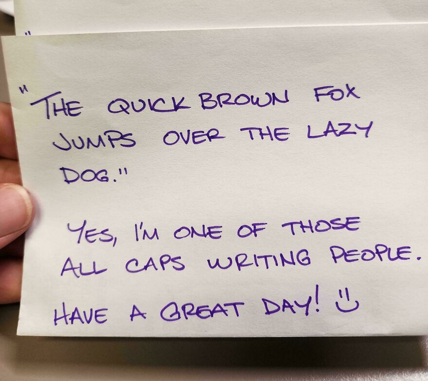 Handwritten note in neat all caps showcasing a perfect handwriting example with a friendly message and smiley face.