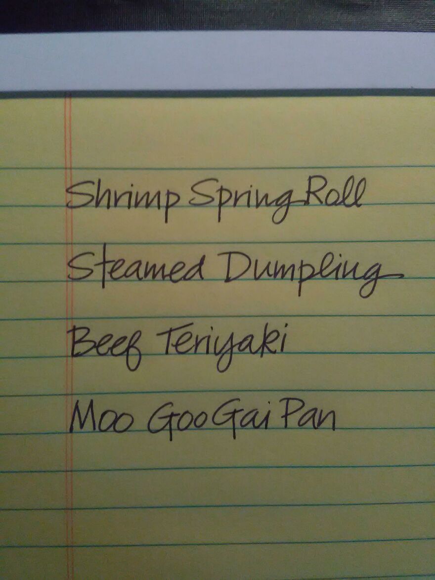 Handwriting example on a yellow notepad listing menu items in perfect handwriting with clear spacing.