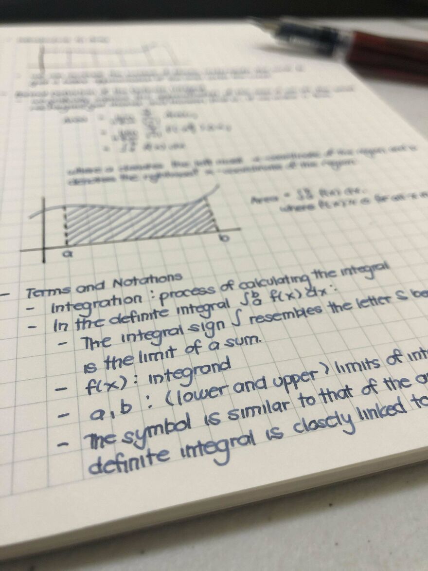 Neatly written math notes on integration with perfect handwriting examples on graph paper, showing clear and organized text.