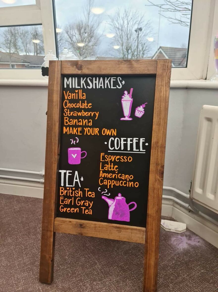 Chalkboard menu with perfect handwriting listing milkshakes, coffee, and tea in colorful orange and white letters.