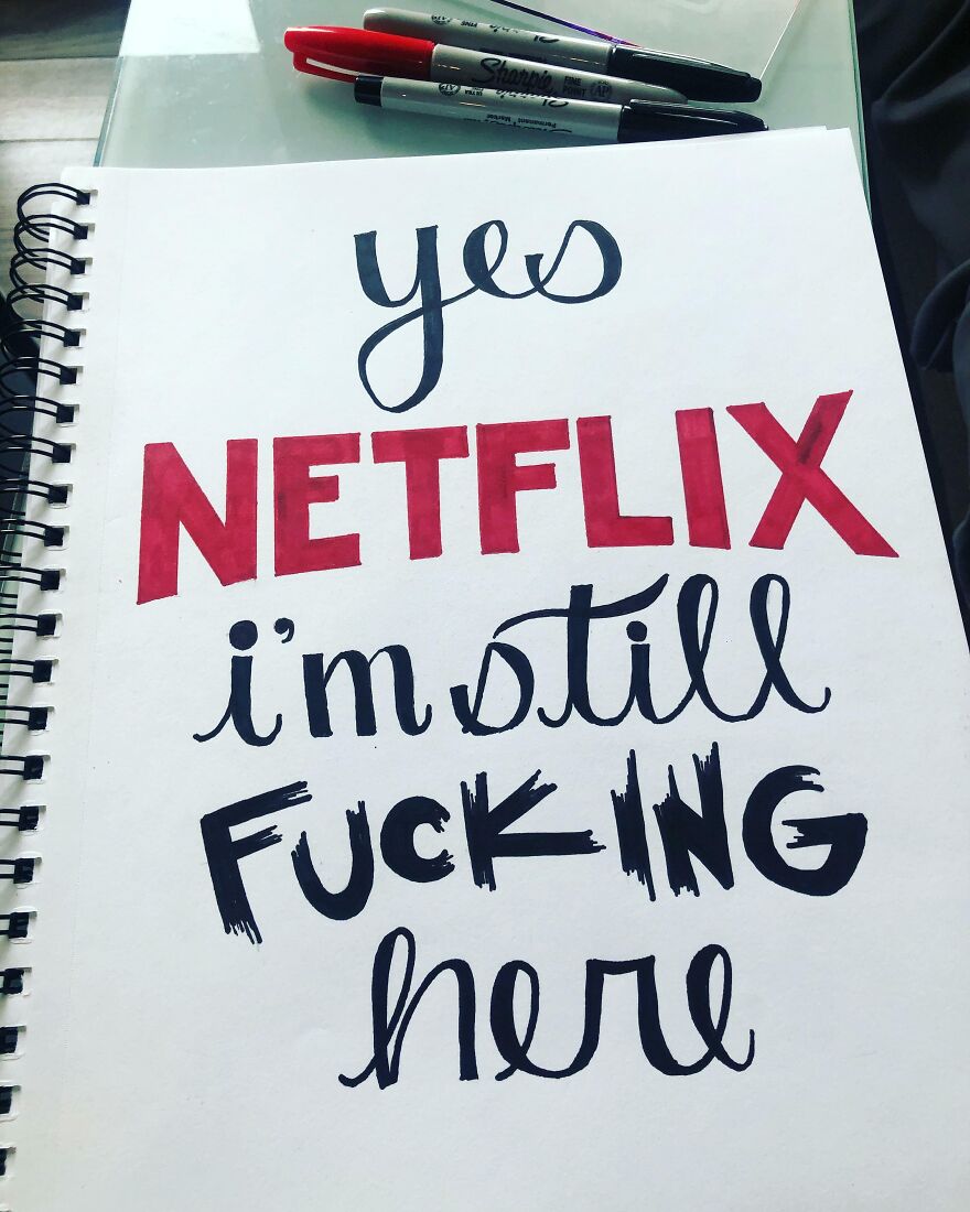 Handwriting example with bold red and black text on white paper, showcasing perfect handwriting in a spiral notebook.