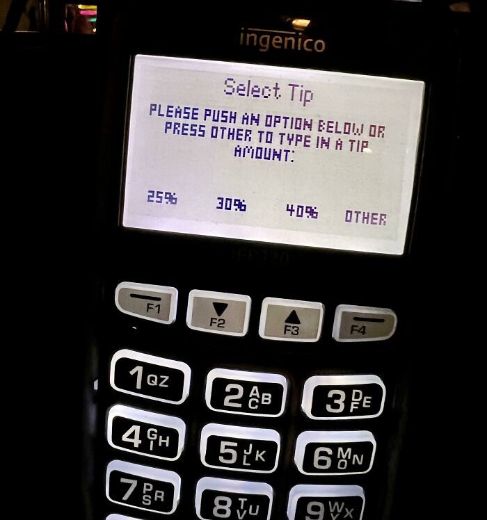 Payment terminal screen prompting to select tip amount, illustrating surprising fees people had every right to be mad about.