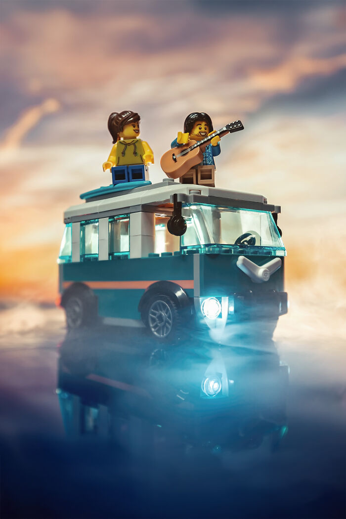 LEGO figures on top of a van with guitar, set in a dramatic Hollywood-level scene with moody lighting and fog effects.