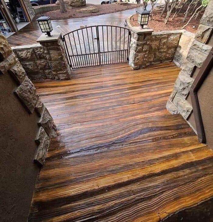 Outdoor stairs designed with concrete stained to look like wood, creating a visually striking and potentially slippery surface.