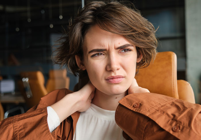 Young woman looking frustrated indoors, illustrating maid of honor demands thousands back after pregnancy weight exclusion conflict. Young woman looking frustrated indoors, illustrating maid of honor demands thousands back after pregnancy weight exclusion conflict.