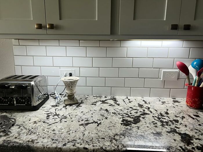 Granite kitchen countertop with best-selling kitchen items including toaster and cooking utensils in a bright kitchen setting