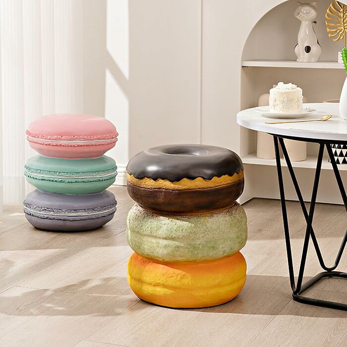 Stacked oversized macaron and donut cushions in a living room highlighting bizarre finds affecting your bank account.