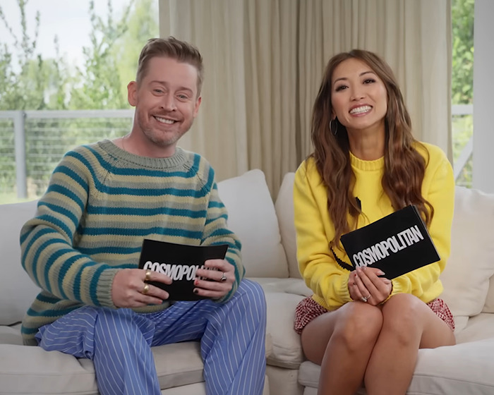 Two hosts sitting on a couch holding cards during an interview about a '90s child star's rare outing at age 44. Two hosts sitting on a couch holding cards during an interview about a '90s child star's rare outing at age 44.
