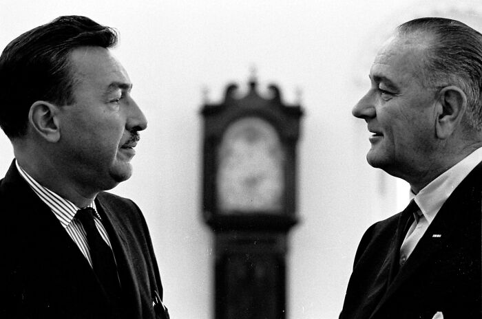 Two men in suits face each other during a historic discussion, symbolizing crucial moments of the Harlem Renaissance.