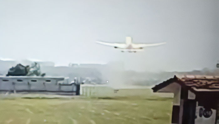 Small plane making unusual take-off over grassy field with buildings nearby, raising expert concerns about evil intent. Small plane making unusual take-off over grassy field with buildings nearby, raising expert concerns about evil intent.