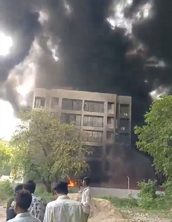 Thick black smoke billows from a building as people watch, linked to a horrifying plane crash and unusual take-off. Thick black smoke billows from a building as people watch, linked to a horrifying plane crash and unusual take-off.