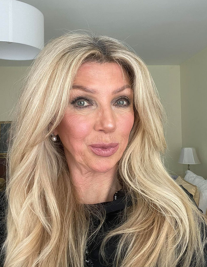 Blonde woman with long hair in a room, representing anti-vax mom of Cambridge graduate who passed away of cancer.