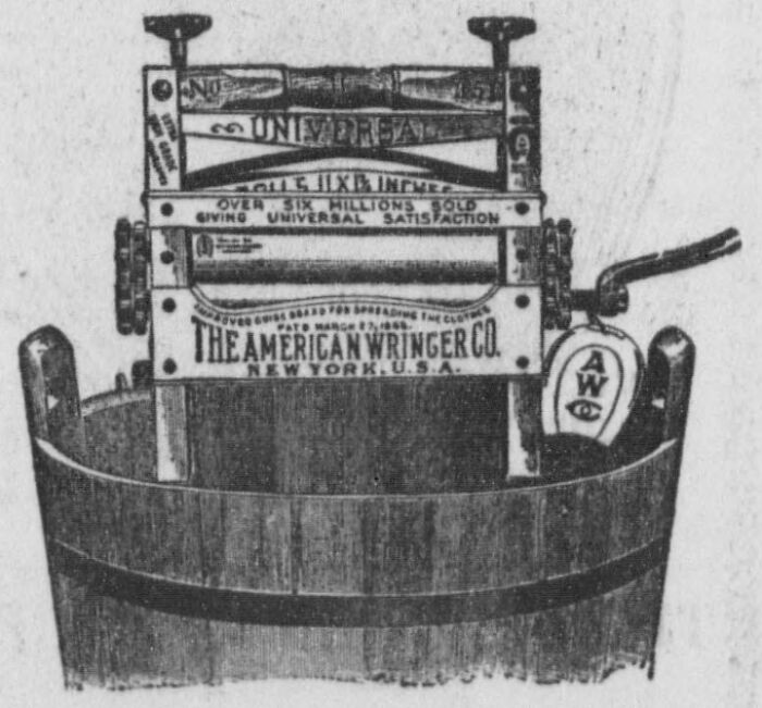 Vintage American wringer washing machine invention by people of color showing early laundry technology in use.