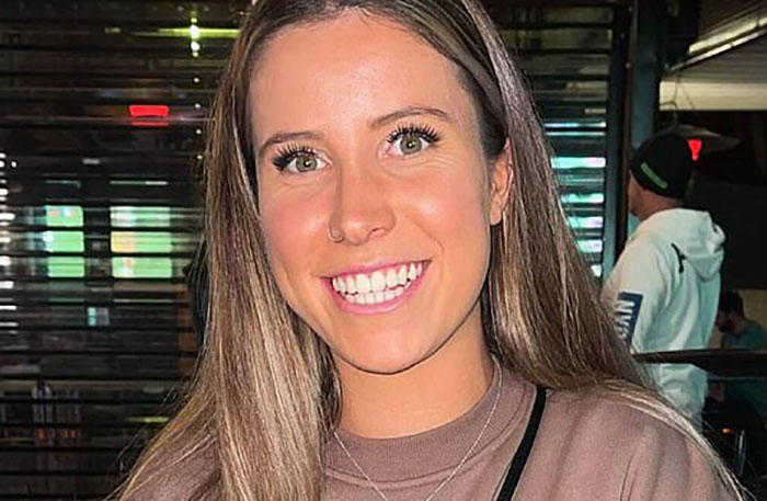 Young woman smiling indoors with long hair, related to incident involving misogynistic comment and lighter sentence request. Young woman smiling indoors with long hair, related to incident involving misogynistic comment and lighter sentence request.
