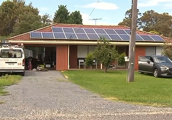 Suburban house with solar panels on roof and parked vehicles, related to woman who set male friend on fire case. Suburban house with solar panels on roof and parked vehicles, related to woman who set male friend on fire case.