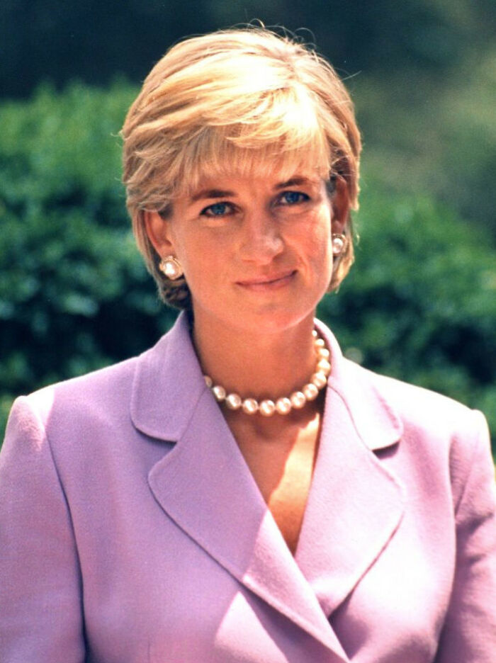 Portrait of a remarkable mother wearing a lavender suit and pearl necklace, symbolizing mothers who shaped the world.
