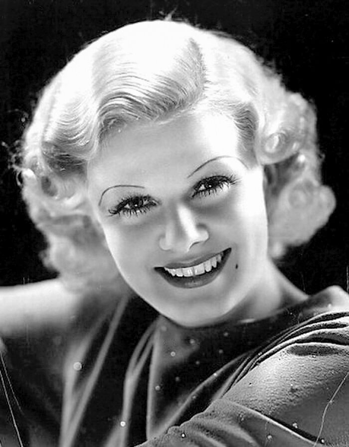 Classic Hollywood star smiling with wavy hair in a vintage black and white portrait, representing stars lost too soon.
