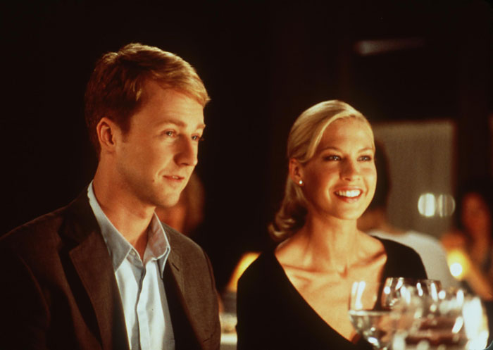 Famous '90s actress with a youthful look, smiling at a formal event with dim lighting and wine glasses. Famous '90s actress with a youthful look, smiling at a formal event with dim lighting and wine glasses.