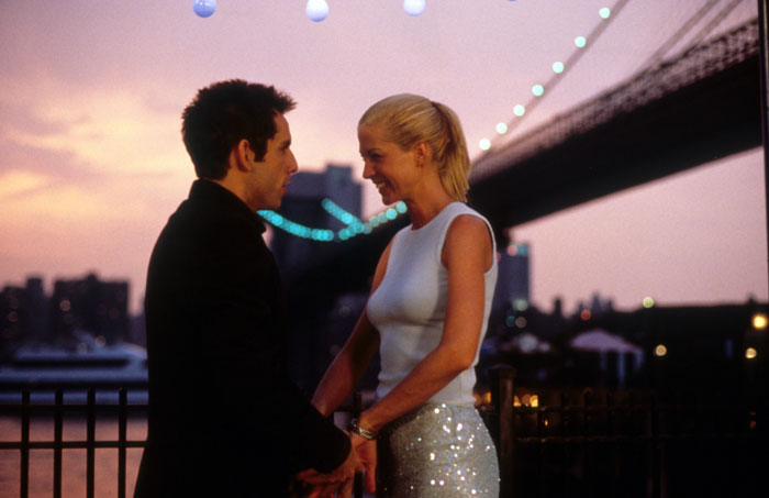Famous 90s actress aged 53 smiling with a man during a rare public outing at sunset near a city bridge. Famous 90s actress aged 53 smiling with a man during a rare public outing at sunset near a city bridge.