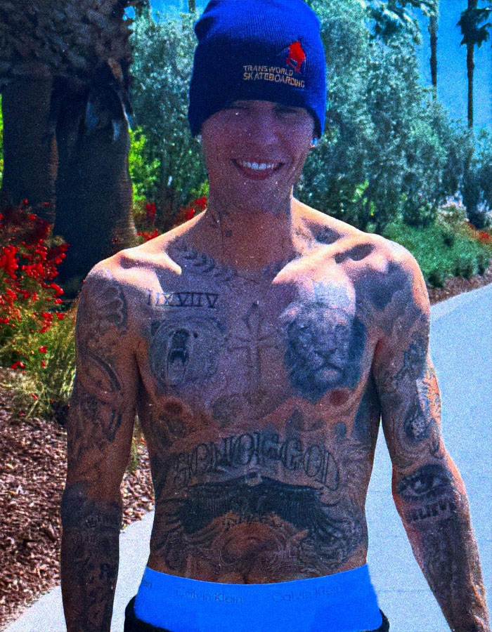 Justin Bieber shirtless outdoors, wearing a blue beanie, showing tattoos in a viral paparazzi moment about being a real man. Justin Bieber shirtless outdoors, wearing a blue beanie, showing tattoos in a viral paparazzi moment about being a real man.
