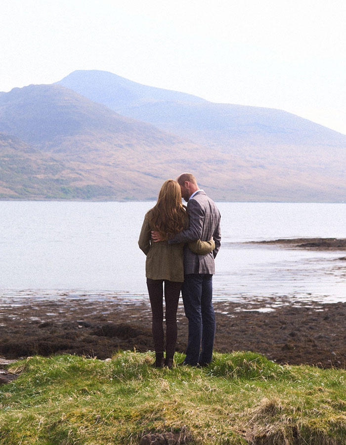 Kate Middleton and Prince William standing on grass by a lake with hills, celebrating Prince William's birthday. Kate Middleton and Prince William standing on grass by a lake with hills, celebrating Prince William's birthday.
