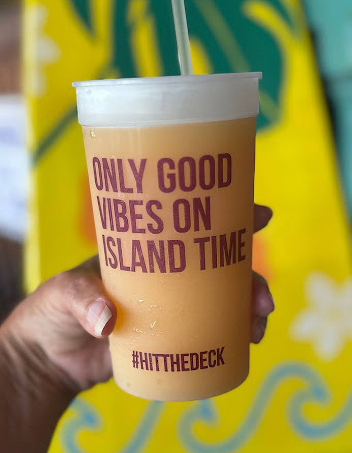 Cold beverage in a plastic cup with text only good vibes on island time held at Siesta Key beach hidden gems. Cold beverage in a plastic cup with text only good vibes on island time held at Siesta Key beach hidden gems.