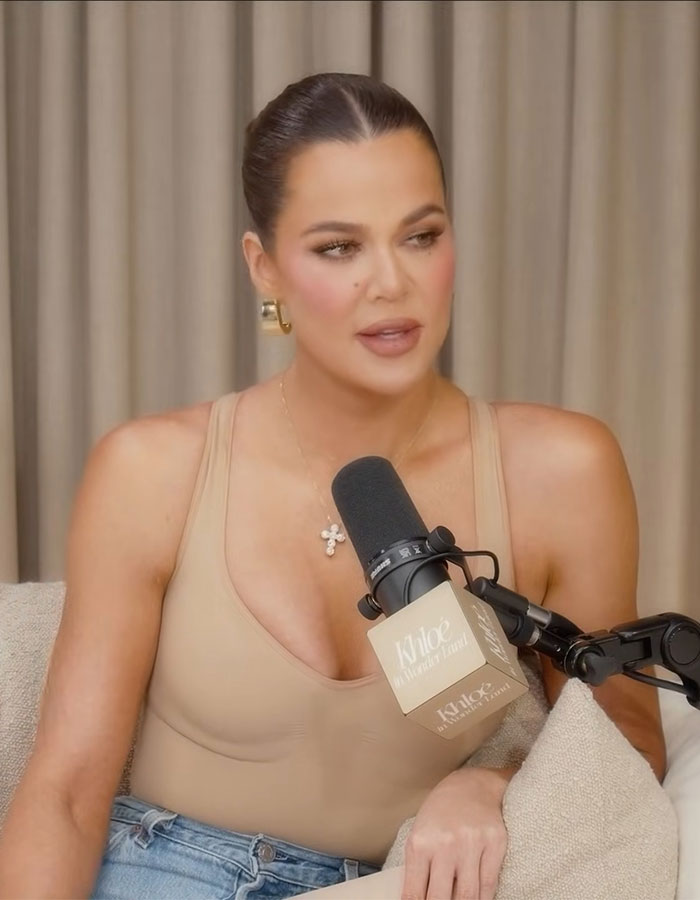 Khloé Kardashian speaking into a microphone during a podcast, addressing weight loss trolls and Ozempic speculation. Khloé Kardashian speaking into a microphone during a podcast, addressing weight loss trolls and Ozempic speculation.