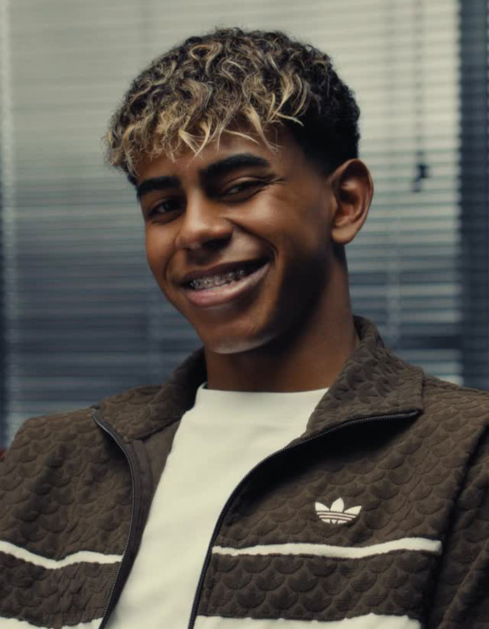 Smiling young man with braces and curly hair, wearing a brown jacket, relating to main SEO keywords about relationship and comment. Smiling young man with braces and curly hair, wearing a brown jacket, relating to main SEO keywords about relationship and comment.