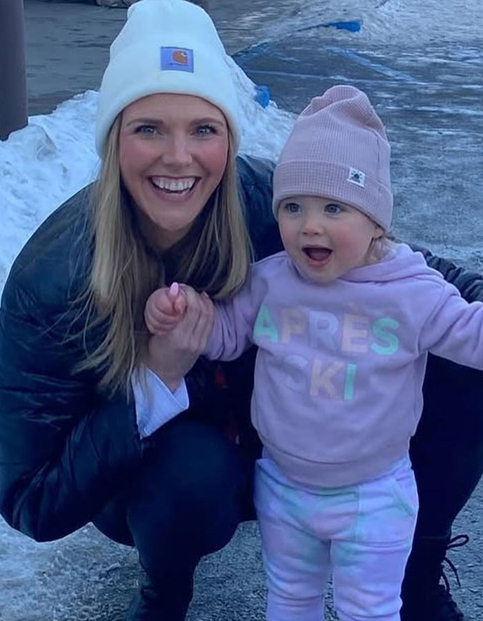 Smiling woman and toddler outside in winter gear, relevant to Real Housewives exec passes away during childbirth news. Smiling woman and toddler outside in winter gear, relevant to Real Housewives exec passes away during childbirth news.
