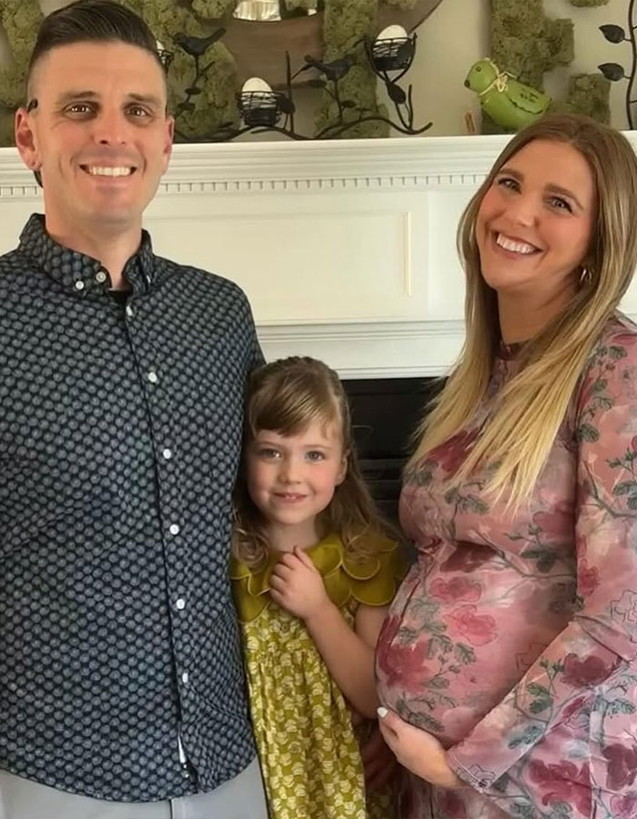 Family portrait with pregnant woman, child, and man, illustrating real housewives exec and childbirth tragedy context. Family portrait with pregnant woman, child, and man, illustrating real housewives exec and childbirth tragedy context.