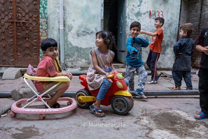 Children playing in a worn urban setting, capturing the unseen realities of our world through the photographer’s lens.