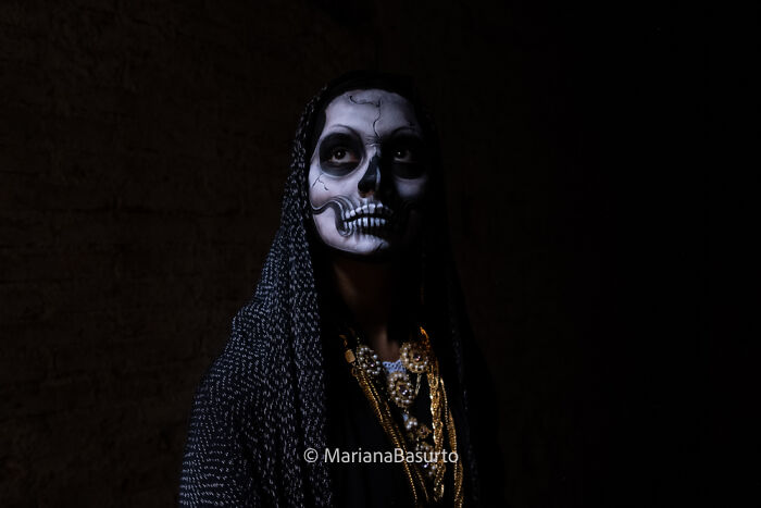 Portrait of a person with skull face paint and dark clothing, capturing the unseen realities through striking photography.