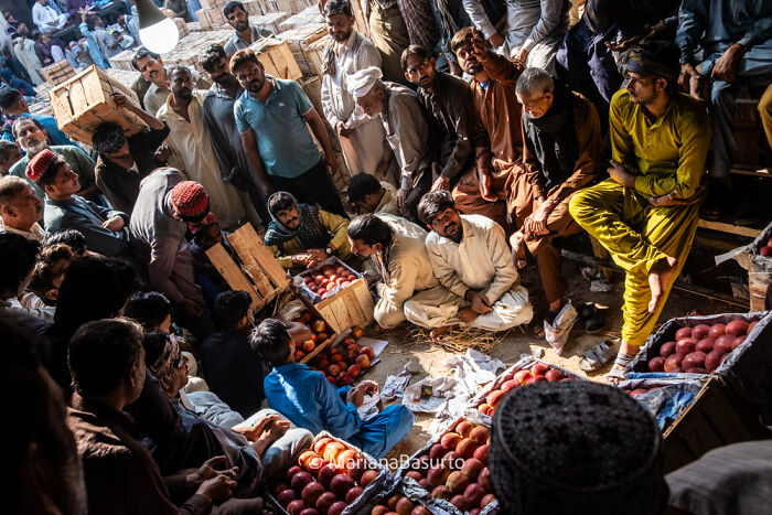 A crowded marketplace scene captured by a photographer revealing the unseen realities of daily life and culture.