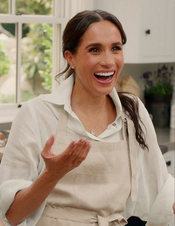 Meghan Markle smiling and gesturing in a kitchen setting, linked to viral pregnancy twerk video mastermind plan. Meghan Markle smiling and gesturing in a kitchen setting, linked to viral pregnancy twerk video mastermind plan.