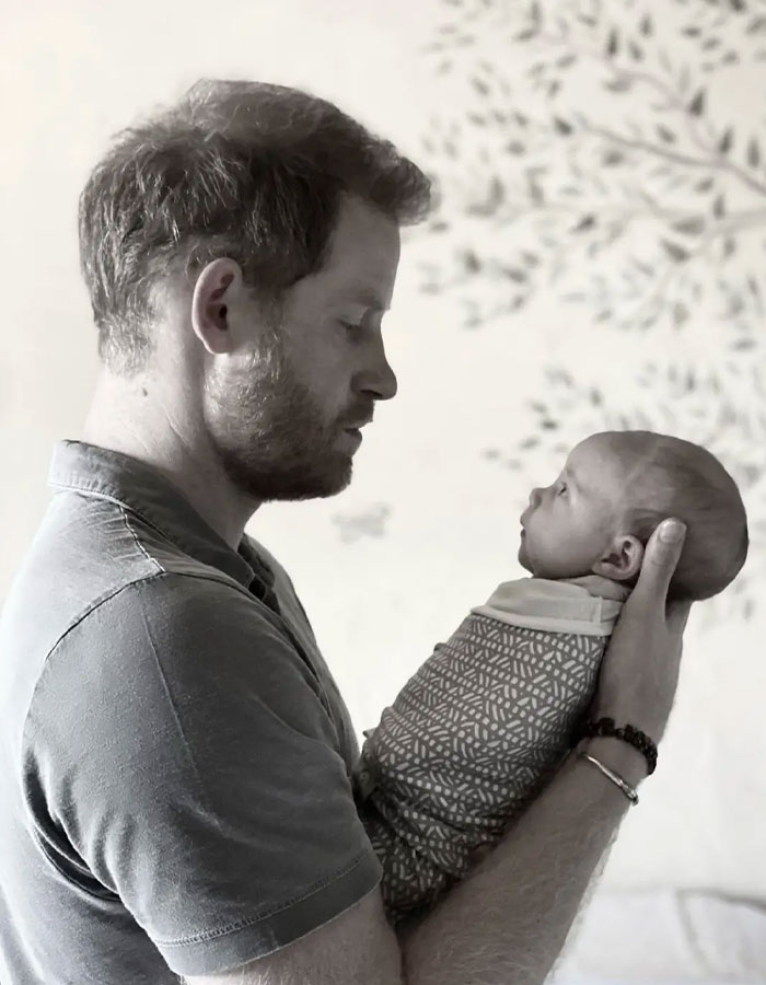 Man holding a newborn baby wrapped in a blanket, symbolizing Meghan Markle's mastermind plan behind viral pregnancy twerk video. Man holding a newborn baby wrapped in a blanket, symbolizing Meghan Markle's mastermind plan behind viral pregnancy twerk video.