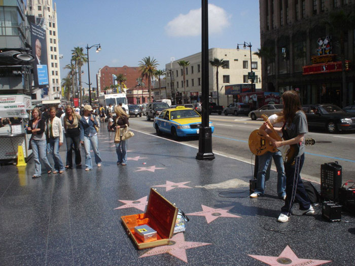 Street musicians performing on Hollywood Walk of Fame as doctors speculate about Miley Cyrus’ brutal infection root cause. Street musicians performing on Hollywood Walk of Fame as doctors speculate about Miley Cyrus’ brutal infection root cause.