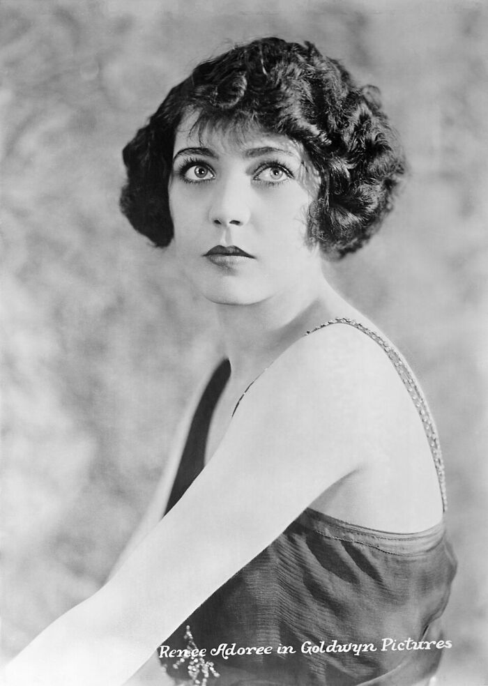 Black and white portrait of a woman with short curly hair, representing stars lost too soon in the 20th century.