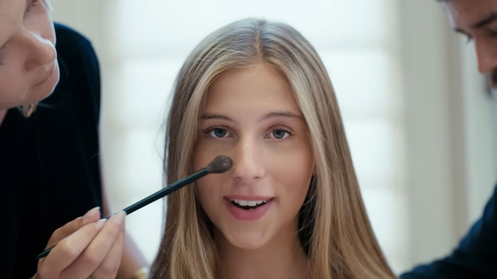 Young woman getting makeup applied, representing a nepo grandbaby involved in a song directed by her mom. Young woman getting makeup applied, representing a nepo grandbaby involved in a song directed by her mom.