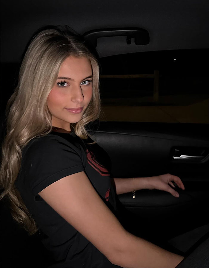 Young woman sitting in a car at night, representing nepo grandbaby involved in a song directed by mom. Young woman sitting in a car at night, representing nepo grandbaby involved in a song directed by mom.