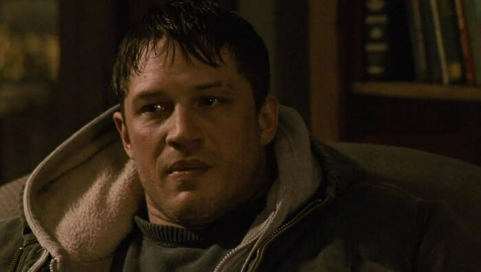 Close-up of a man in a dark jacket indoors, representing one of the new millennium's greatest films to see.