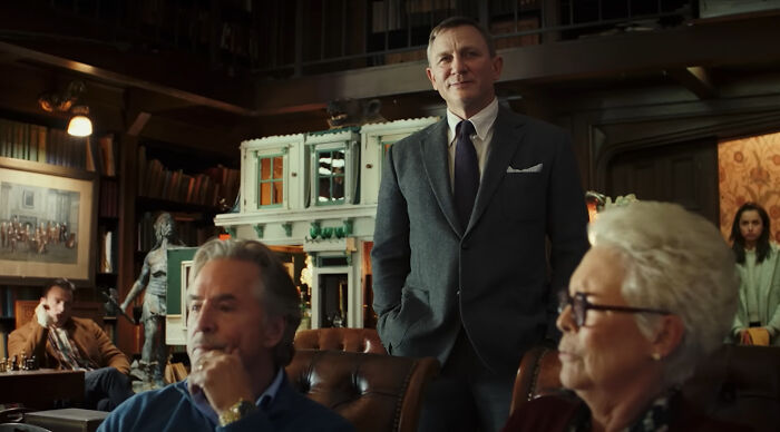 Actor Daniel Craig in a classic film scene, dressed in a suit, representing iconic films of the new millennium.