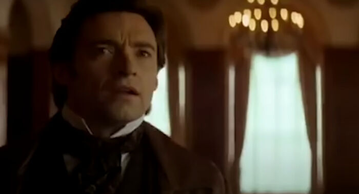 Actor in a dramatic scene from one of the new millennium’s greatest films, showcasing intense emotion in a period setting.