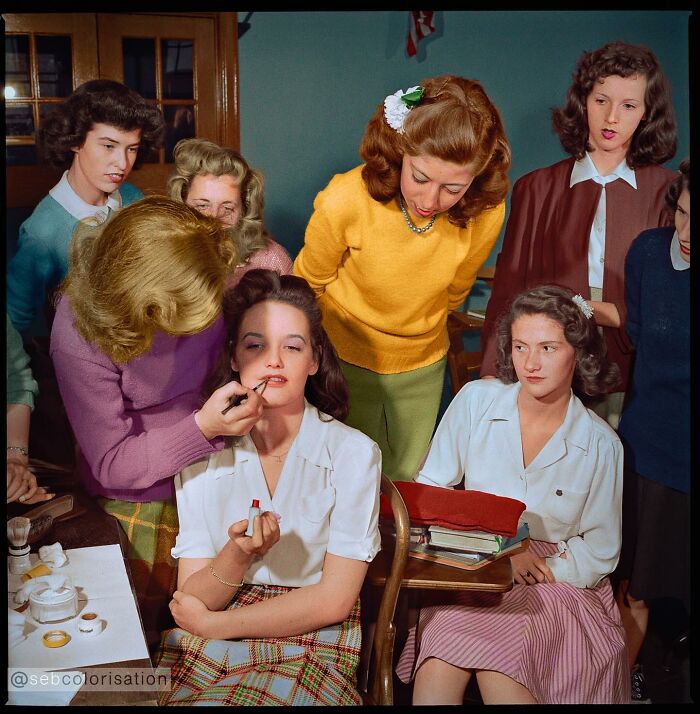 Colorized historical photo of women applying makeup and observing, showcasing magical historical photos by a talented viral artist.