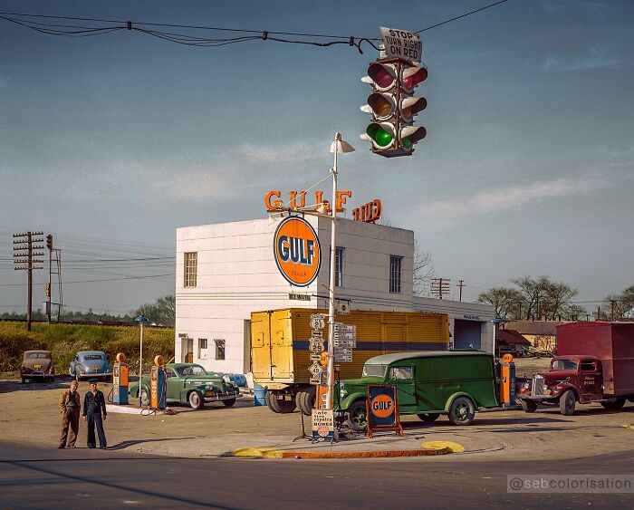 Colorized historical photo of a vintage Gulf gas station with classic cars and traffic light, showcasing magical historical art.