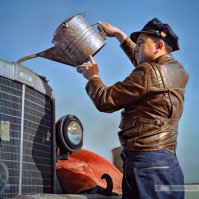 Man in leather jacket pouring oil into vintage car engine in a colorized historical photo by viral artist