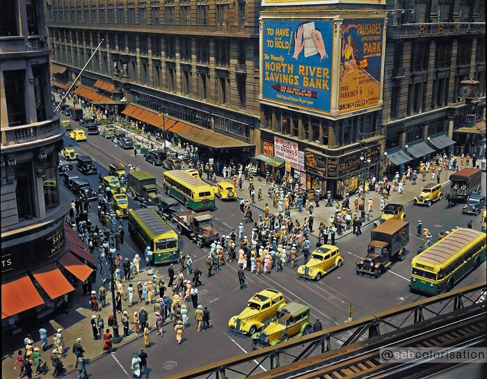 Colorized historical photo showing a busy city intersection with vintage cars and crowds in a magical scene