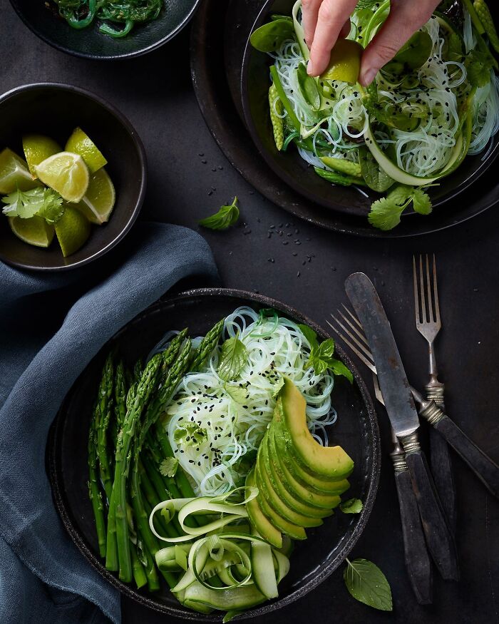 Fresh green vegetable salad with avocado, asparagus, and noodles, a mouthwatering food photo by Kai Stiepel.
