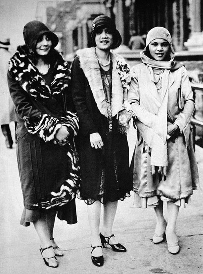 Three stylish women wearing 1920s fashion, representing a significant moment during the Harlem Renaissance era.