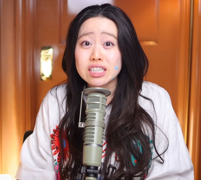 Woman with long dark hair speaking into a microphone, revealing Diddy's aged look in court during trial discussion. Woman with long dark hair speaking into a microphone, revealing Diddy's aged look in court during trial discussion.