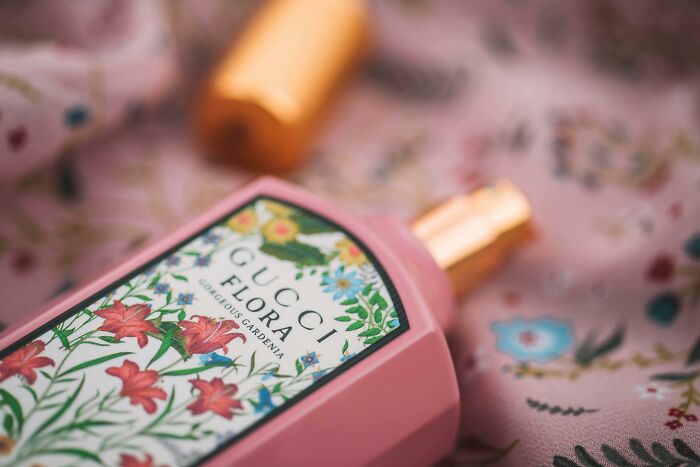 Pink Gucci Flora perfume bottle with floral design, highlighting unique baby names that secretly weird people out.